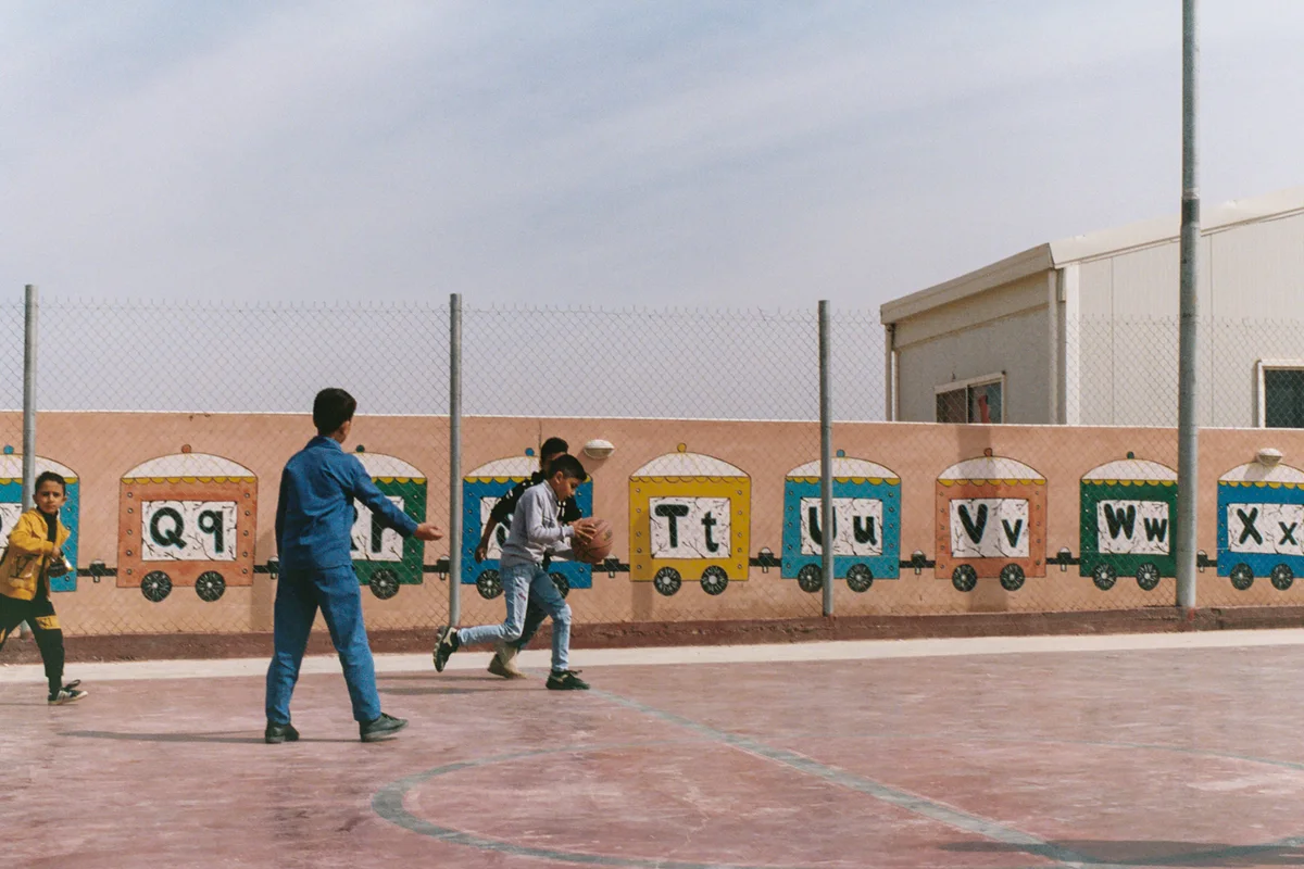 Azraq Center students playing basketball.